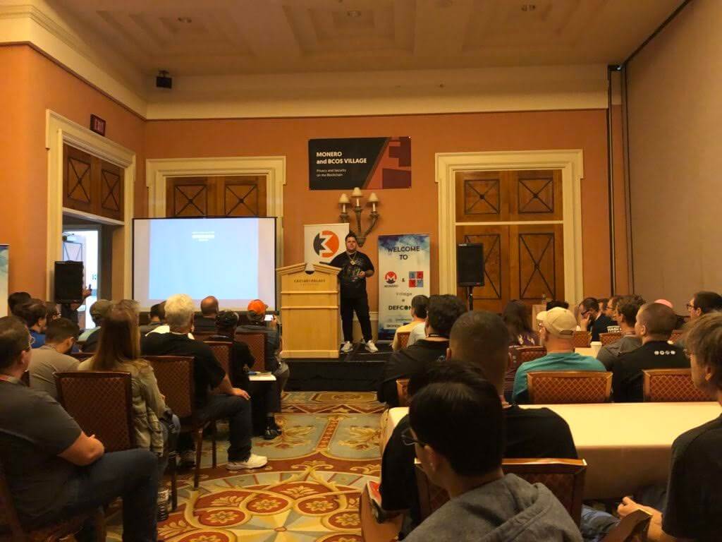 Picture of fluffypony making a presentation in front of a crowd at DEFCON